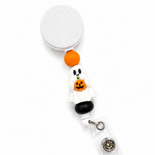 Ghost With Pumpkin badge reel featuring a white ghost holding a smiling jack-o'-lantern with orange, black, and white decorative beads on a retractable badge reel.