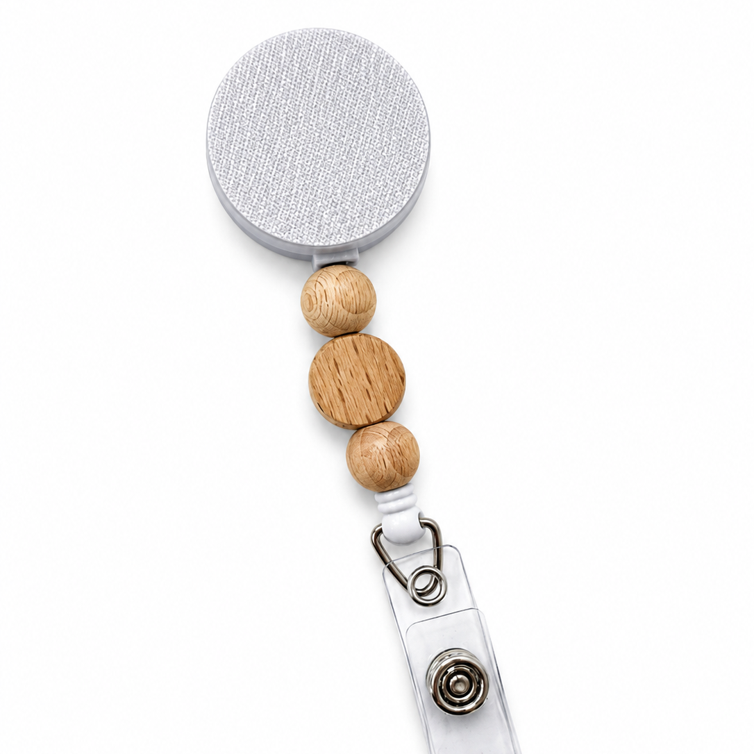 Modern Oak badge reel featuring three natural wood decorative beads on a white retractable badge reel. Minimalist beaded work badge accessory with a natural wood design.