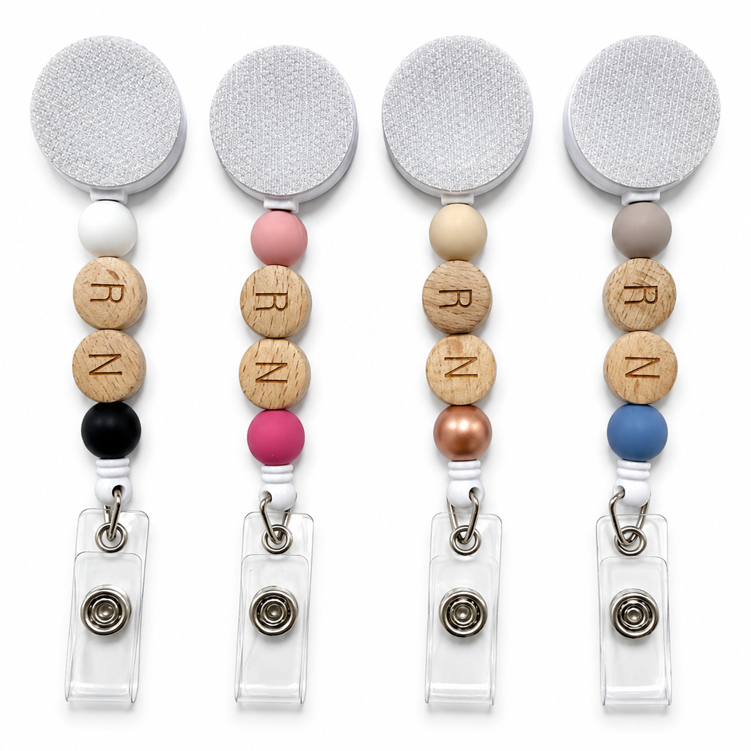 RN badge reel featuring engraved wooden R and N letter beads with decorative silicone accent beads on a white retractable badge reel. Available in four color options for nurses and healthcare professionals.